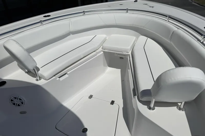 Slide: The Image of 2026 Sportsman Open 252 Center Console boat interior with white cushioned seating. - 16