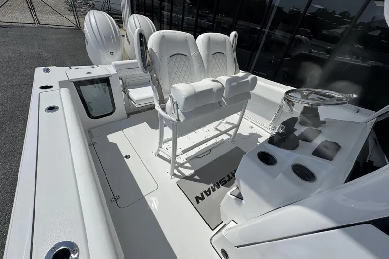 Slide: The Image of 2026 Sportsman Open 252 Center Console boat interior with dual seats and steering console. - 18