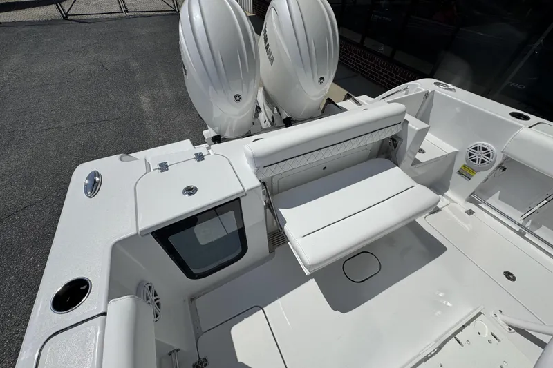 Slide: The Image of 2026 Sportsman Open 252 Center Console boat interior with dual engines and seating area. - 20