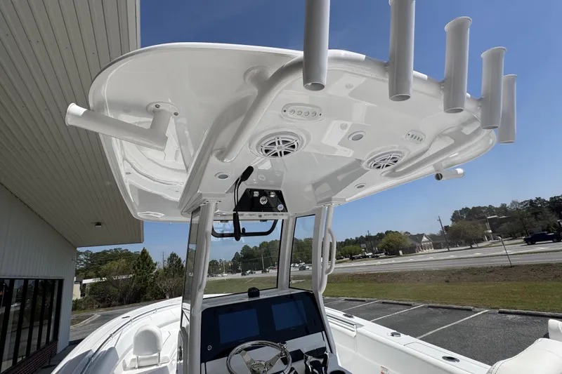 Slide: The Image of 2026 Sportsman Open 252 Center Console boat with advanced helm and rod holders. - 23