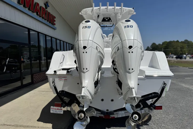 Slide: The Image of 2026 Sportsman Open 252 Center Console with twin 150 horsepower engines at a marine dealership. - 4