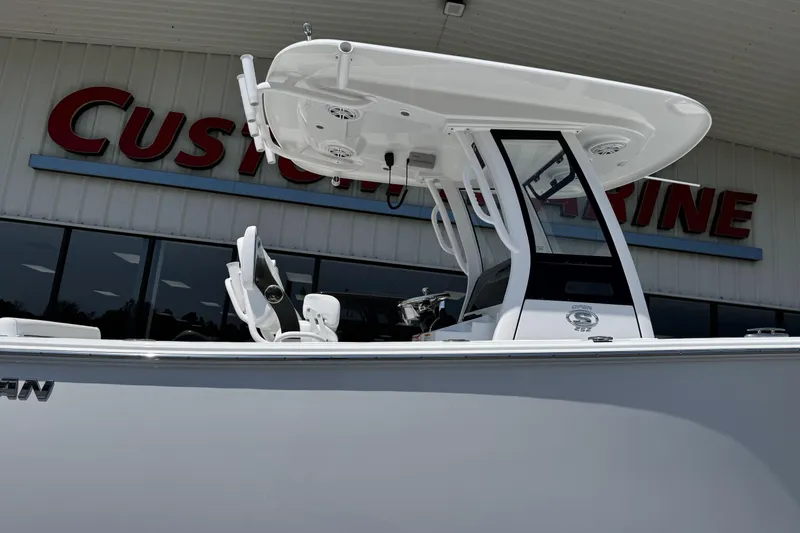Slide: The Image of 2026 Sportsman Open 252 Center Console boat displayed at Custom Marine dealership. - 6