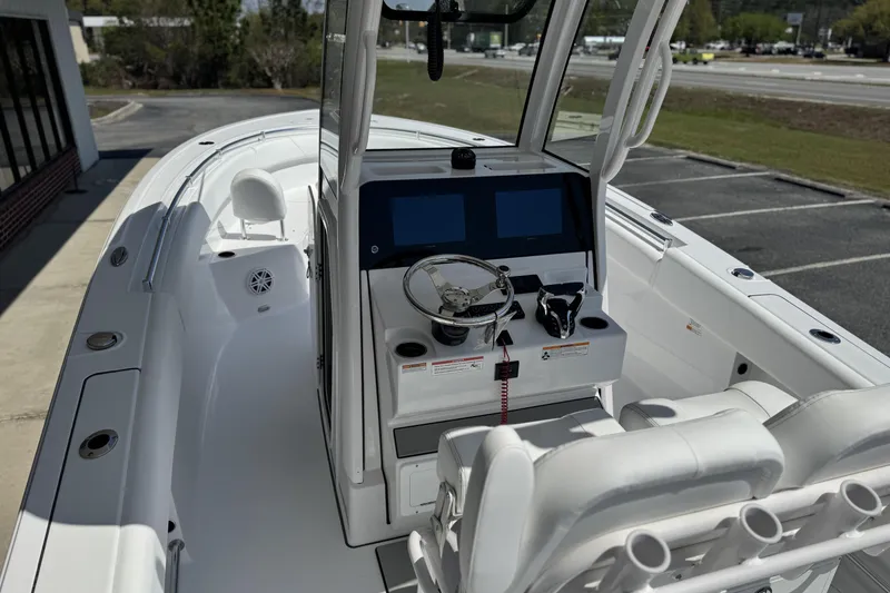 Slide: The Image of 2026 Sportsman Open 252 Center Console boat interior with dual screens and steering wheel. - 9