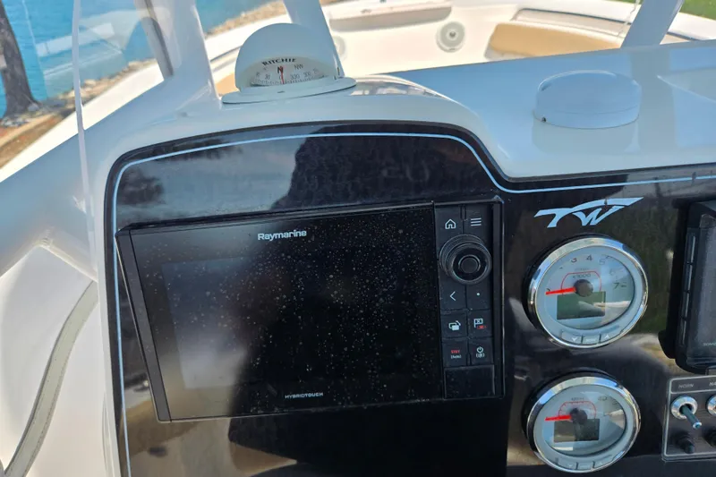 Slide: The Image of Dashboard of a 2016 Tidewater 220 LXF boat with Raymarine display and gauges. - 14