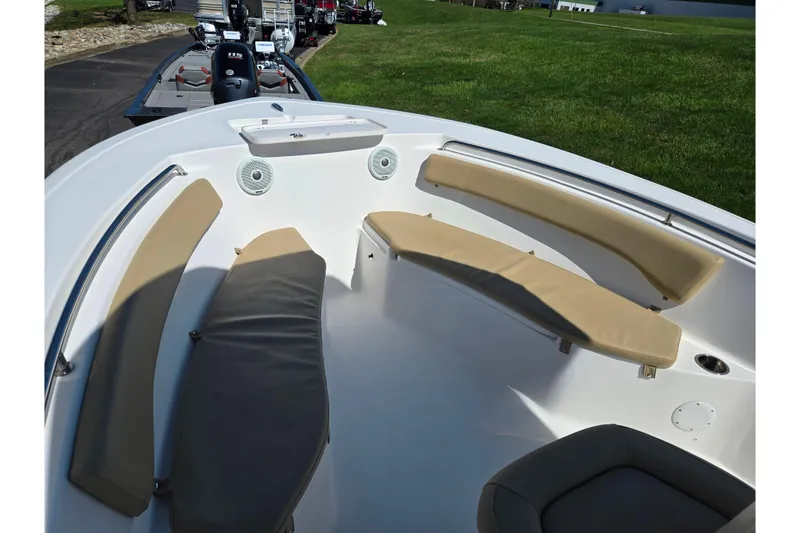 Slide: The Image of 2016 Tidewater 220 LXF boat interior with beige seating and spacious layout. - 15