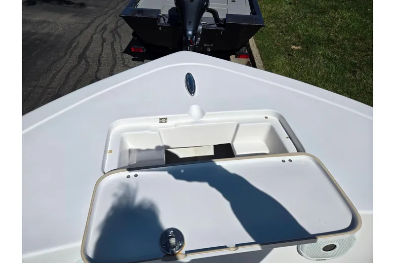 Slide: The Image of 2016 Tidewater 220 LXF boat bow with open storage compartment. - 16