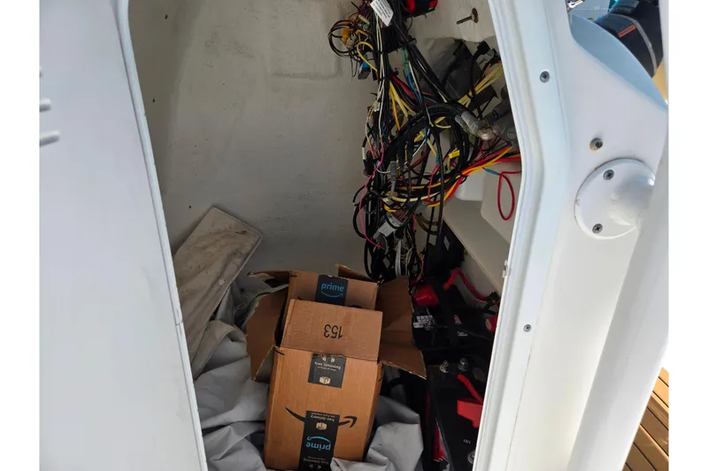 Slide: The Image of Interior of 2016 Tidewater 220 LXF boat showing wiring and storage boxes. - 19