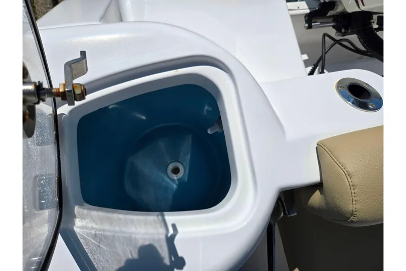 Slide: The Image of Livewell on a 2016 Tidewater 220 LXF boat, featuring a blue interior and beige seating. - 22