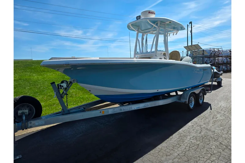 Slide: The Image of 2016 Tidewater 220 LXF boat on trailer under clear blue sky. - 5