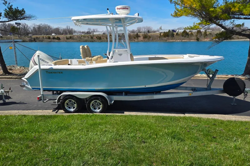 Slide: The Image of 2016 Tidewater 220 LXF boat on trailer by a scenic lake. - 9