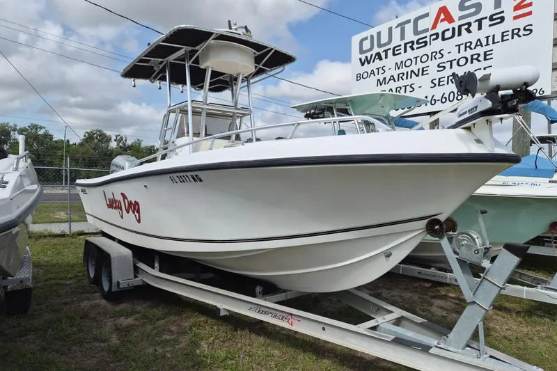The Image of 2002 Mako 221 Center Console boat on trailer at Outcast Watersports dealership. - 1