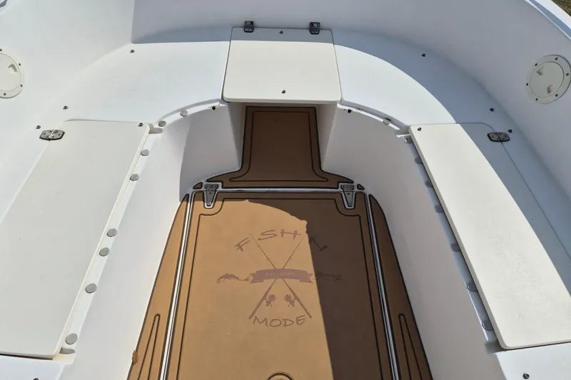 Slide: The Image of 2002 Mako 221 Center Console boat interior with custom flooring and seating. - 10