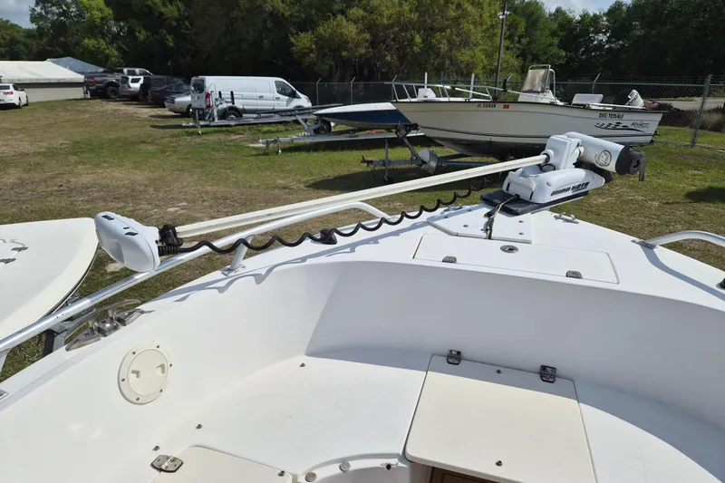 Slide: The Image of 2002 Mako 221 Center Console boat with trolling motor in a grassy lot. - 11