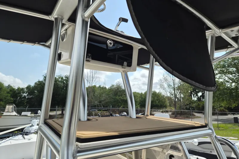 Slide: The Image of 2002 Mako 221 Center Console boat with T-top and storage compartment. - 13