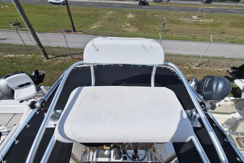 Slide: The Image of 2002 Mako 221 Center Console boat with elevated seating and dual outboard motors. - 15