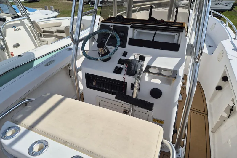 Slide: The Image of 2002 Mako 221 Center Console boat interior with steering wheel and control panel. - 7
