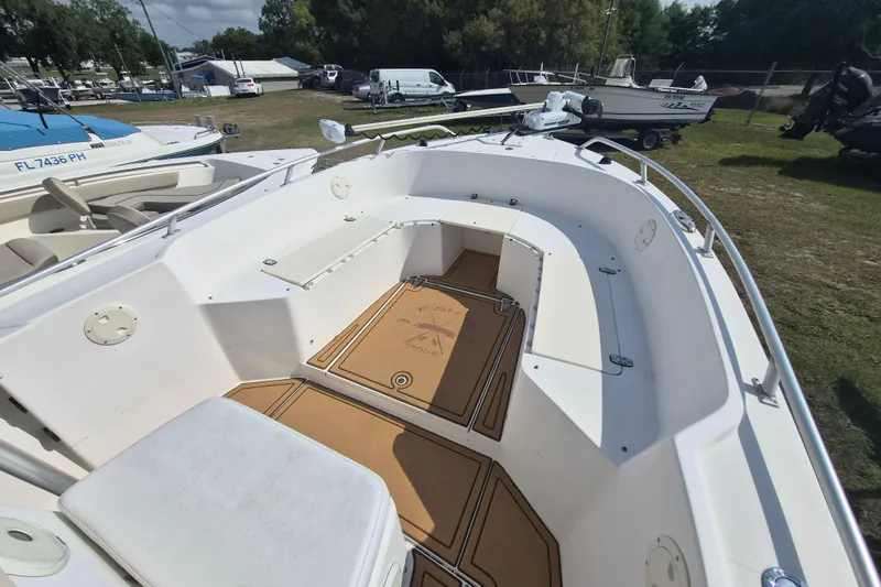 Slide: The Image of 2002 Mako 221 Center Console boat with spacious deck and seating, displayed outdoors. - 9