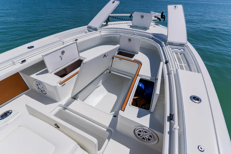 Slide: The Image of 2017 Barker Boatworks 26 with open storage compartments on a calm sea. - 10