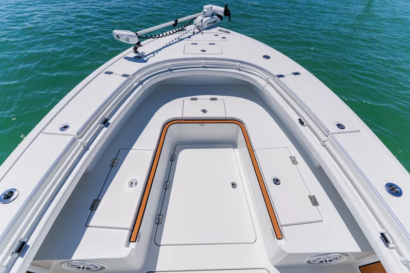 Slide: The Image of 2017 Barker Boatworks 26 model, showcasing sleek deck design on calm waters. - 11