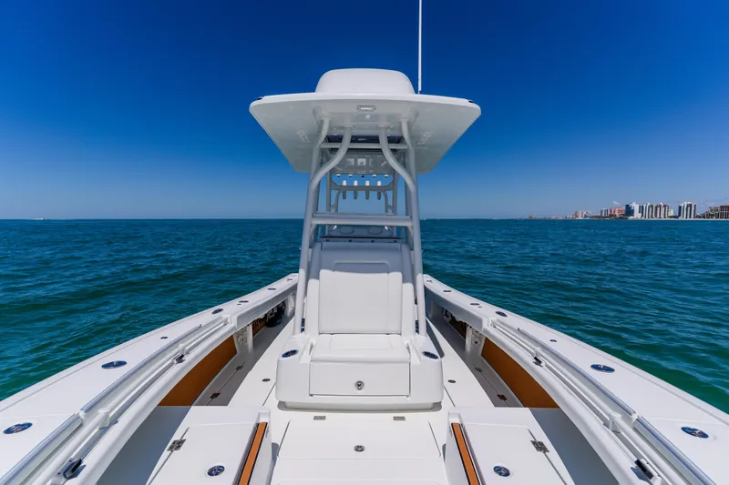 Slide: The Image of 2017 Barker Boatworks 26 on open water with city skyline in background. - 15