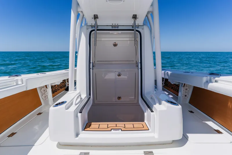 Slide: The Image of 2017 Barker Boatworks 26 model on open water, showcasing sleek design and storage features. - 17