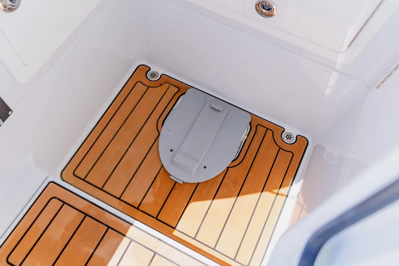 Slide: The Image of 2017 Barker Boatworks 26 interior with teak flooring and storage compartment. - 18