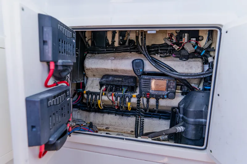 Slide: The Image of Electrical panel inside a 2017 Barker Boatworks 26, showcasing wiring and equipment. - 20