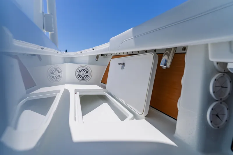 Slide: The Image of Interior view of 2017 Barker Boatworks 26, showcasing storage compartments and speakers. - 22
