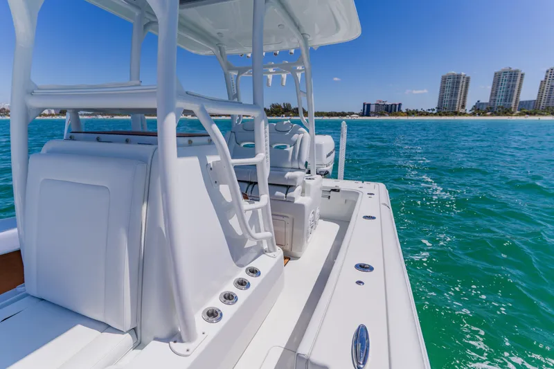 Slide: The Image of 2017 Barker Boatworks 26 on turquoise water near a city skyline. - 24