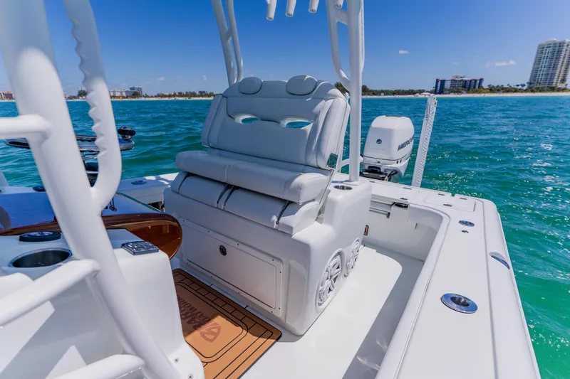 Slide: The Image of 2017 Barker Boatworks 26 on turquoise water, featuring sleek seating and modern design. - 26