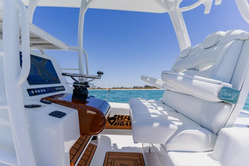 Slide: The Image of 2017 Barker Boatworks 26 helm with white seating and ocean view. - 28