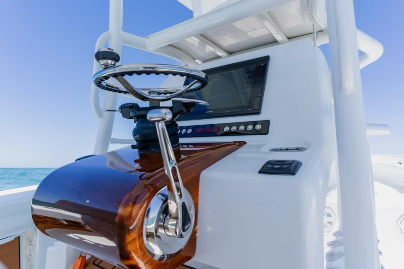 Slide: The Image of 2017 Barker Boatworks 26 helm with polished wood finish and modern navigation system. - 30