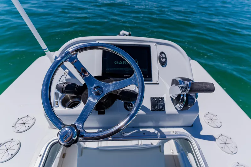 Slide: The Image of Steering console of a 2017 Barker Boatworks 26 on calm water. - 34