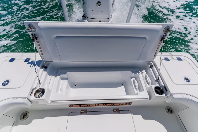 Slide: The Image of Open storage compartment on 2017 Barker Boatworks 26, with ocean waves in the background. - 41