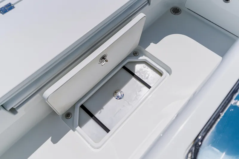 Slide: The Image of 2017 Barker Boatworks 26 storage compartment with secure latch and drainage system. - 44