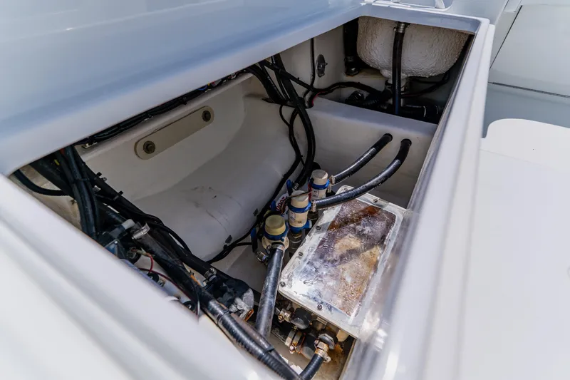 Slide: The Image of Open compartment of a 2017 Barker Boatworks 26, showing internal wiring and components. - 46
