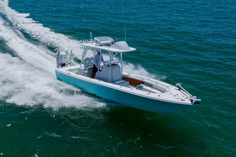 Slide: The Image of 2017 Barker Boatworks 26 cruising on open water, showcasing sleek design and performance. - 5