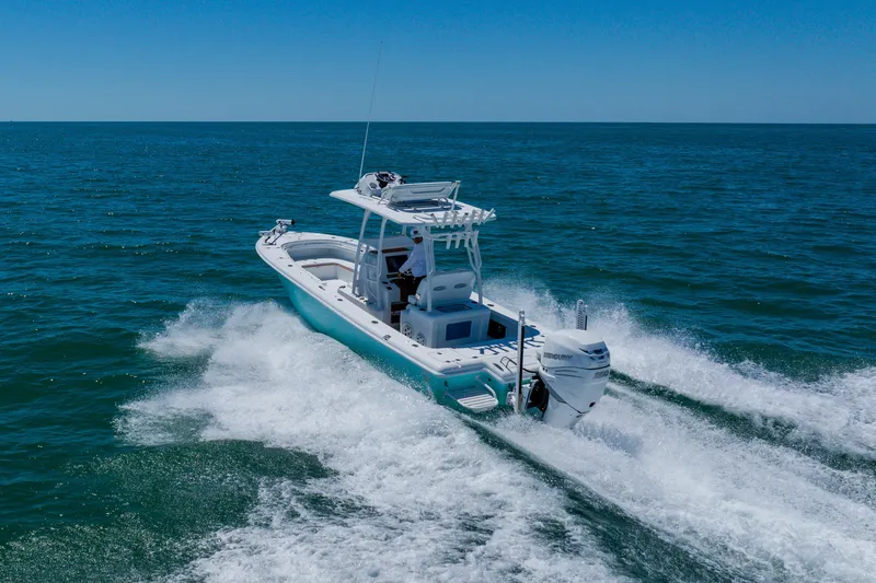 Slide: The Image of 2017 Barker Boatworks 26 cruising on open ocean under clear blue sky. - 6