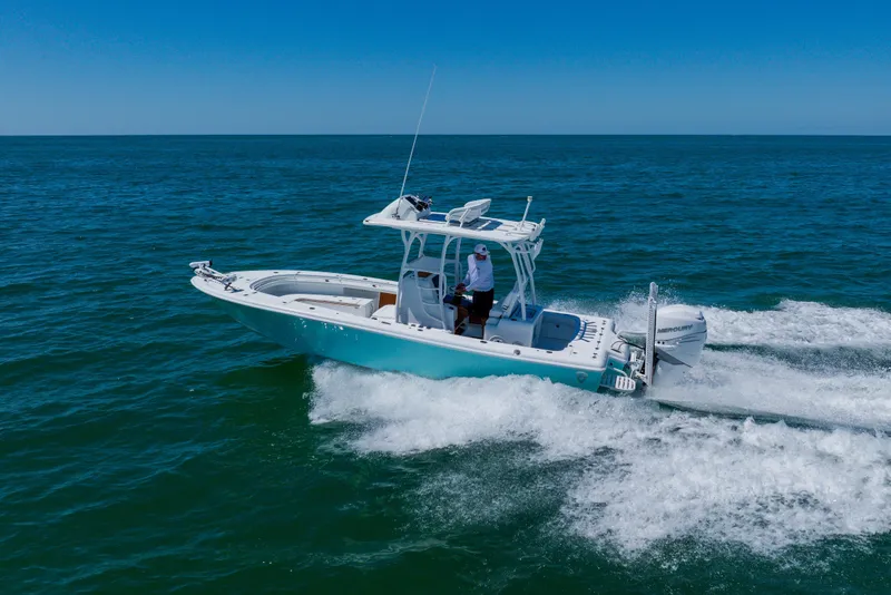Slide: The Image of 2017 Barker Boatworks 26 cruising on open ocean under clear blue sky. - 7