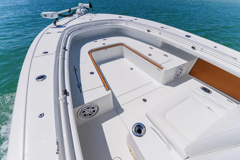 Slide: The Image of 2017 Barker Boatworks 26 model, white deck, spacious seating, on clear blue water. - 8
