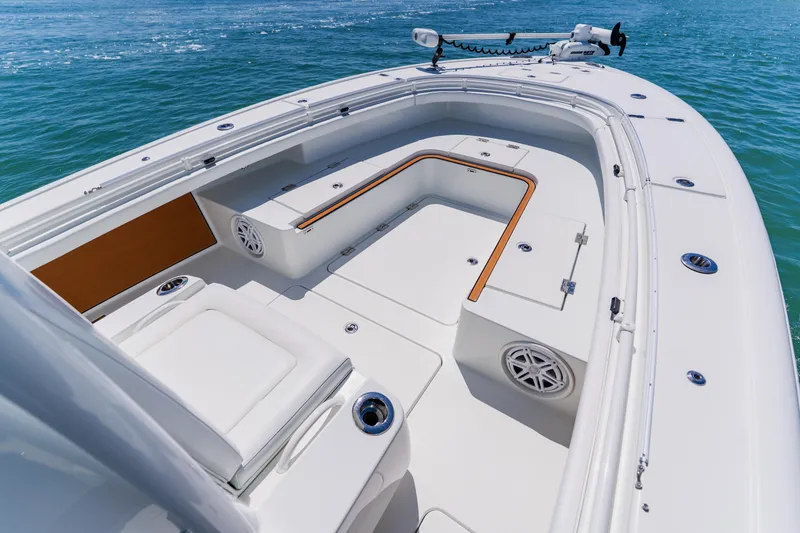 Slide: The Image of 2017 Barker Boatworks 26 model, featuring spacious deck and seating on calm waters. - 9