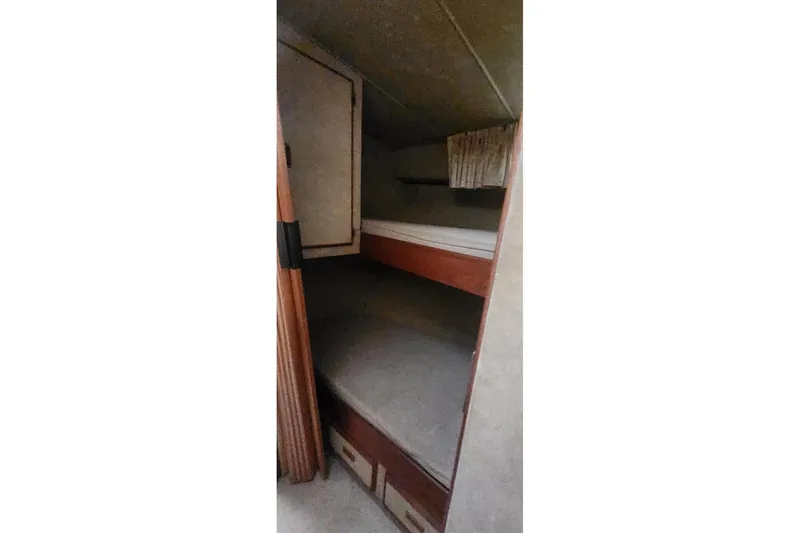 Slide: The Image of Interior cabin of 1985 Bertram 33 Flybridge Cruiser with bunk beds and storage. - 20