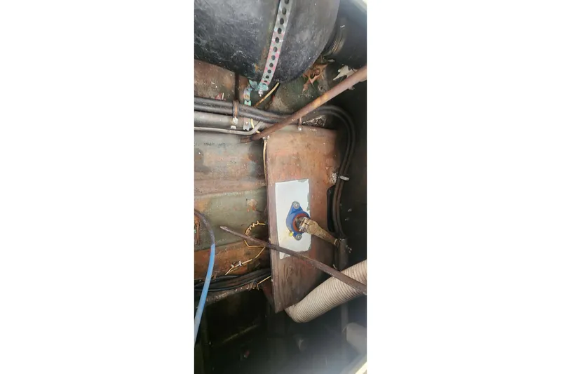 Slide: The Image of Engine compartment of a 1985 Bertram 33 Flybridge Cruiser, showing mechanical components. - 26