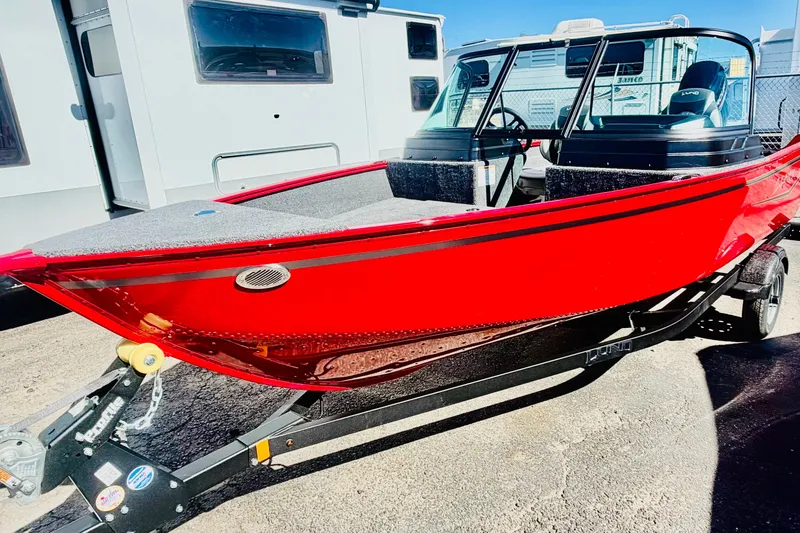 The Image of 2026 Lund 1650 Angler Sport boat in vibrant red on trailer. - 1