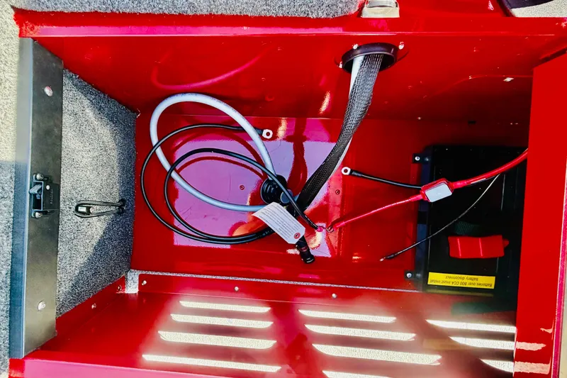 Slide: The Image of Interior view of 2026 Lund 1650 Angler Sport boat compartment with wiring and battery. - 10