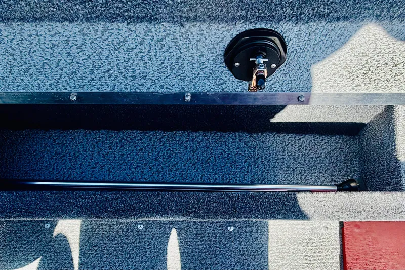 Slide: The Image of Interior view of 2026 Lund 1650 Angler Sport boat compartment with rod storage. - 11