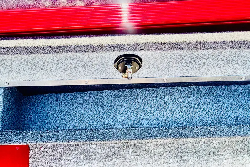 Slide: The Image of Interior view of 2026 Lund 1650 Angler Sport boat with red and gray detailing. - 12