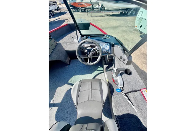 Slide: The Image of Interior view of 2026 Lund 1650 Angler Sport boat, featuring steering wheel and dashboard controls. - 14