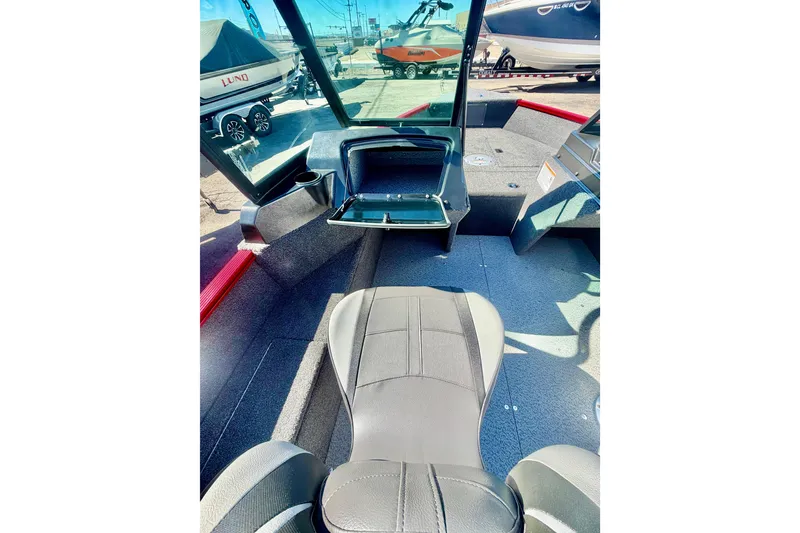 Slide: The Image of 2026 Lund 1650 Angler Sport interior with seating and storage compartments. - 15