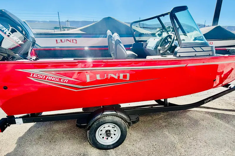 Slide: The Image of Red 2026 Lund 1650 Angler Sport boat on trailer, side view. - 6